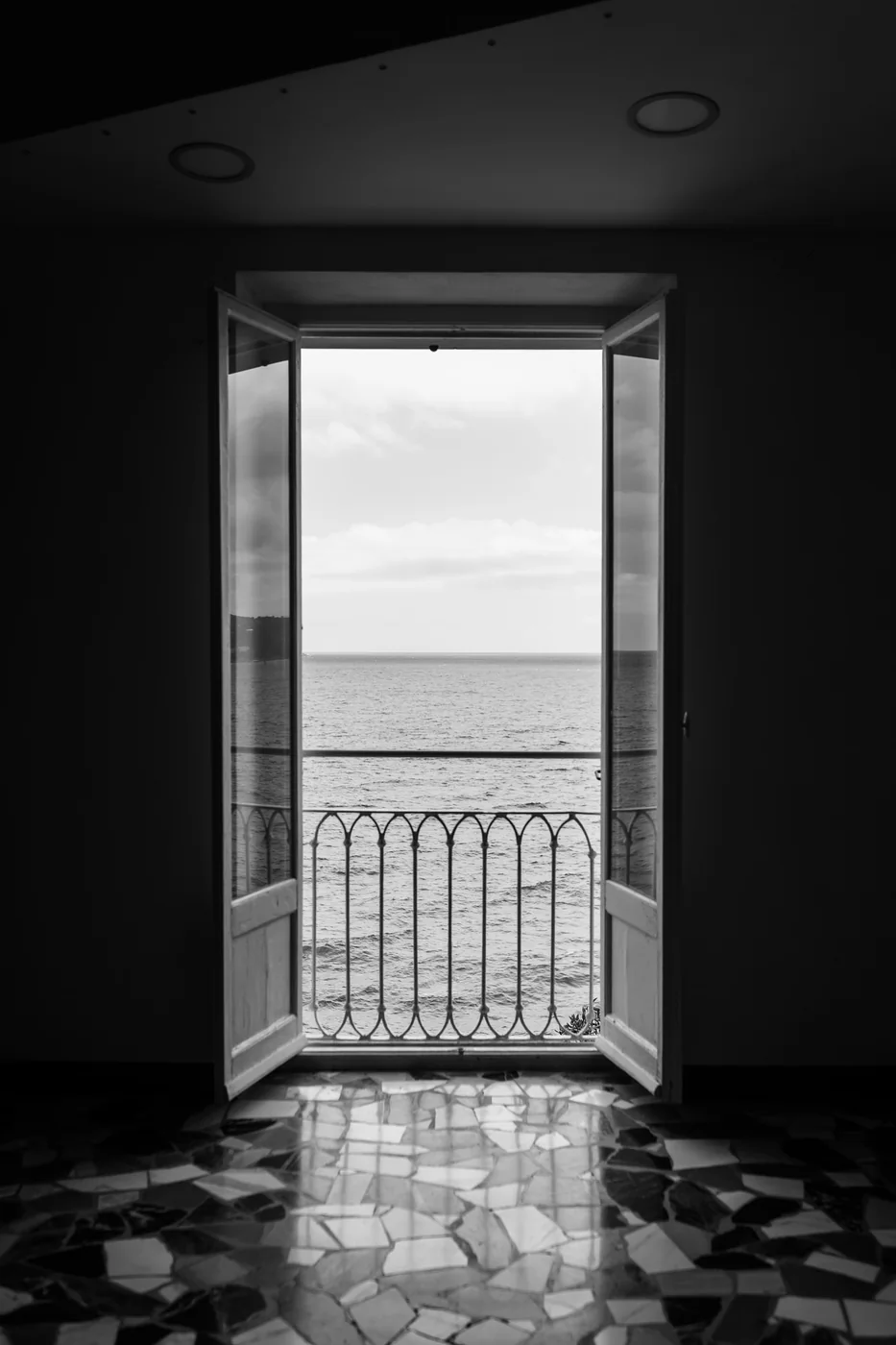 An open window onto the sea from inside Castello Canevaro, in black and white