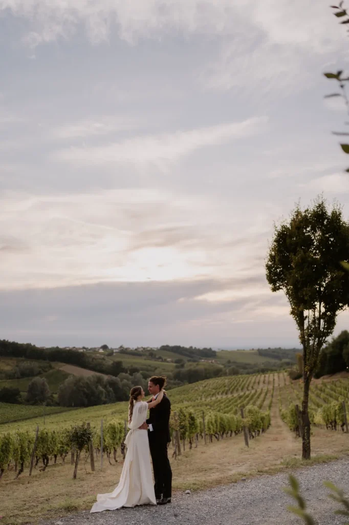 The couple among the vineyards at sunset