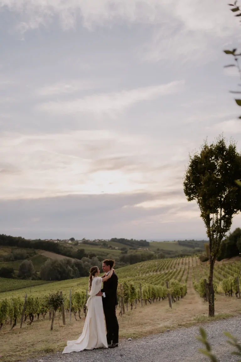 The couple among the vineyards at sunset