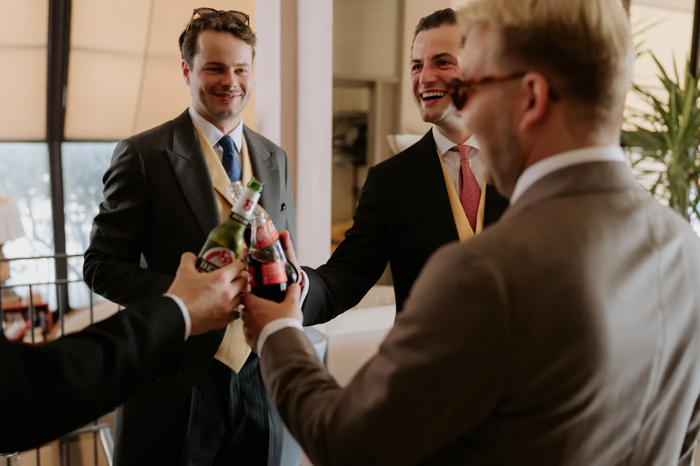 The groom and his friends toasting with beers before the ceremony