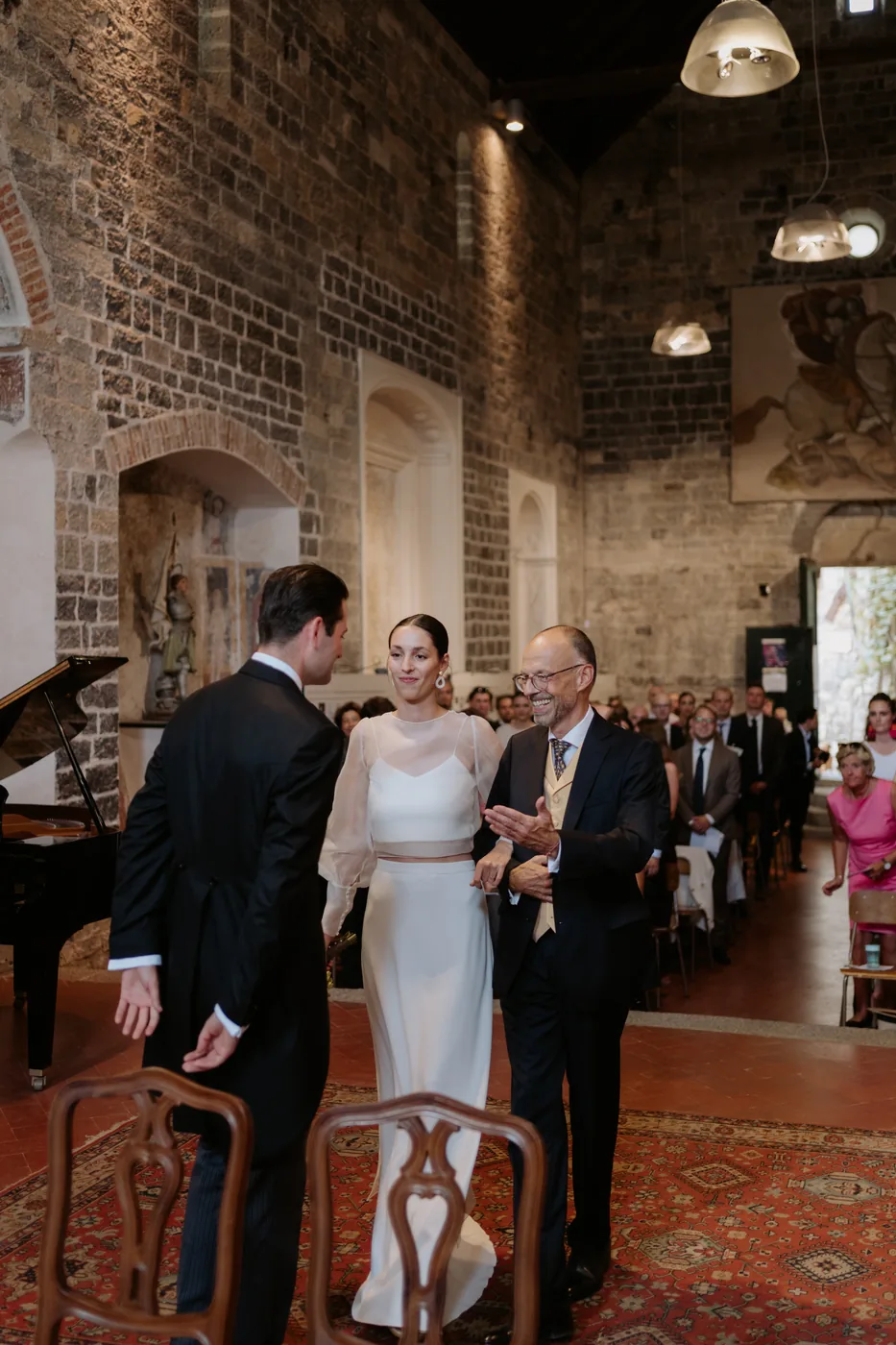 The bride walking to the ceremony with a guest
