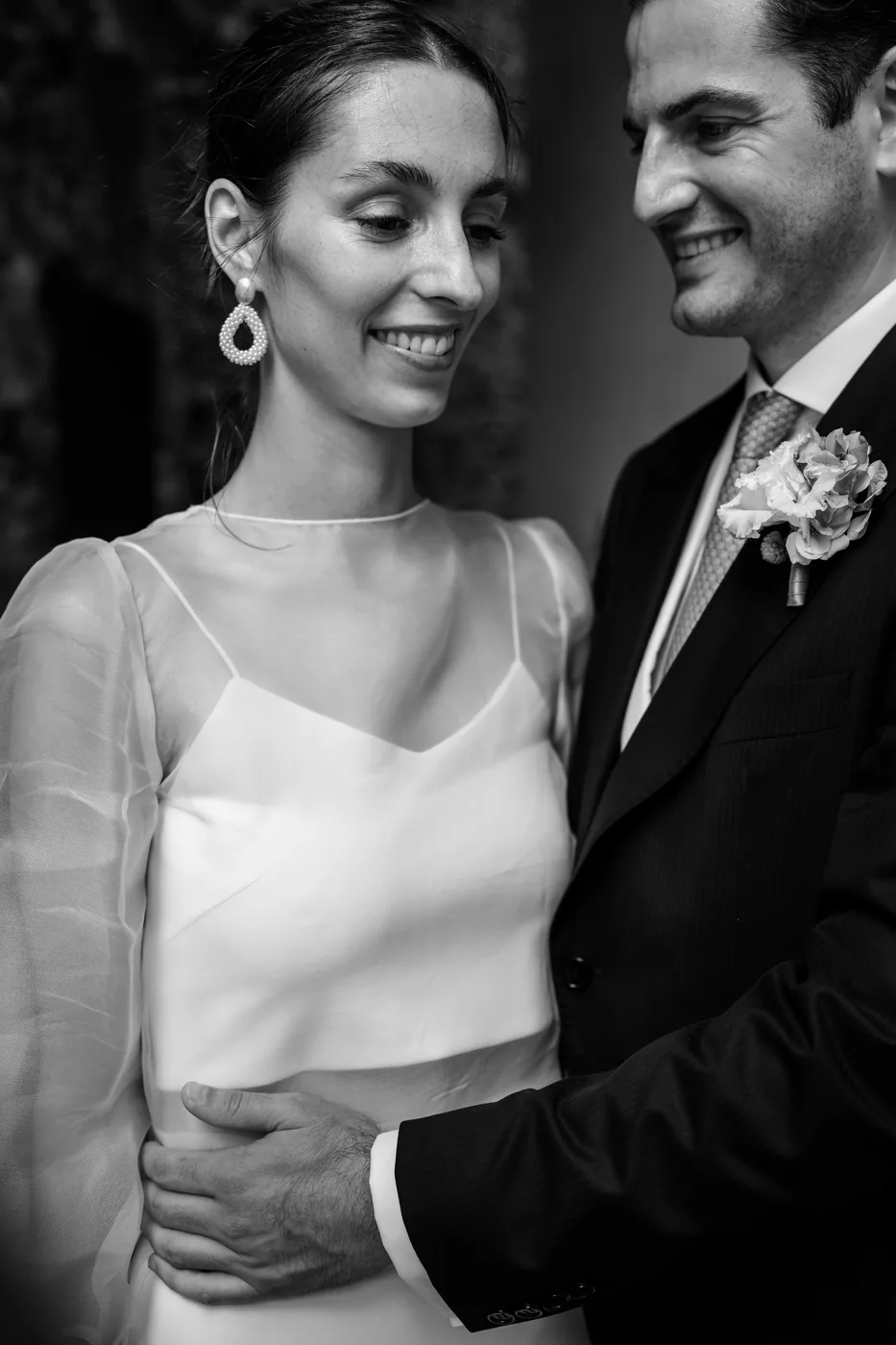 The couple embracing and smiling, in black and white