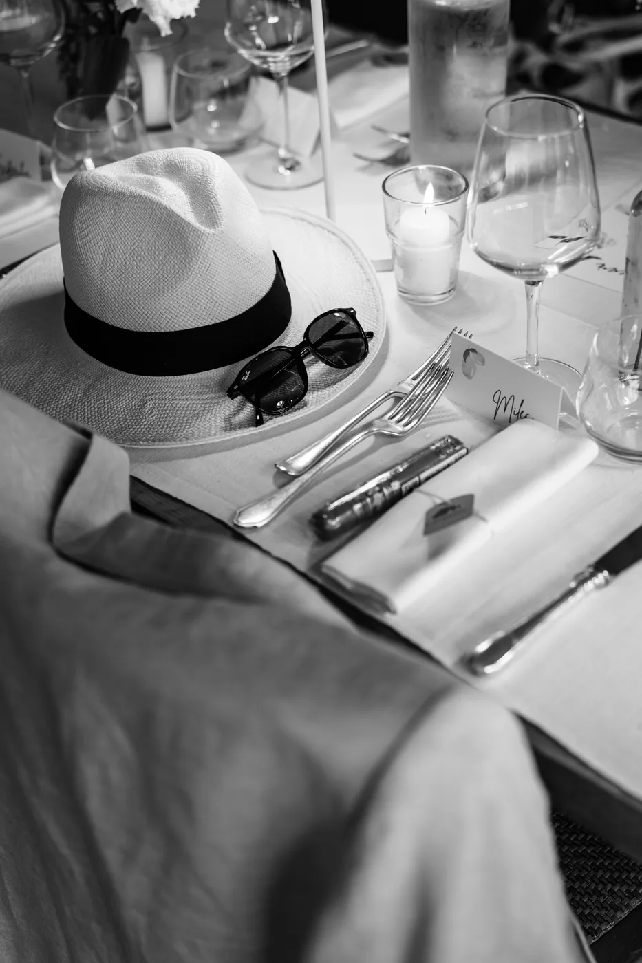 A hat and sunglasses on the set table, in black and white
