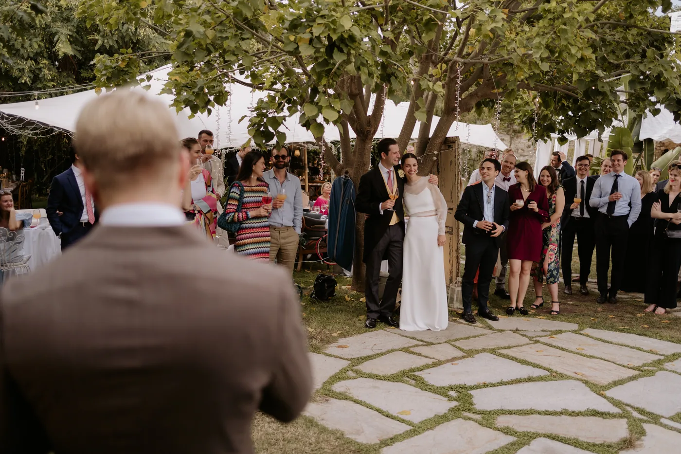 The couple listening to the speech, surrounded by their guests