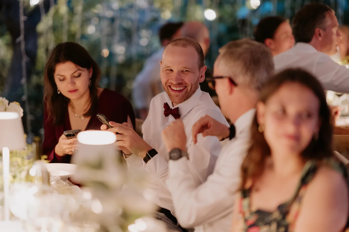 Guests laughing at the table during dinner