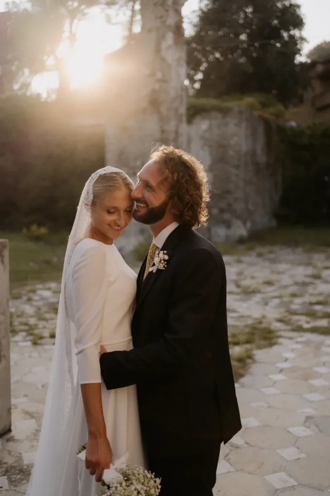 The couple forehead to forehead in the golden afternoon light