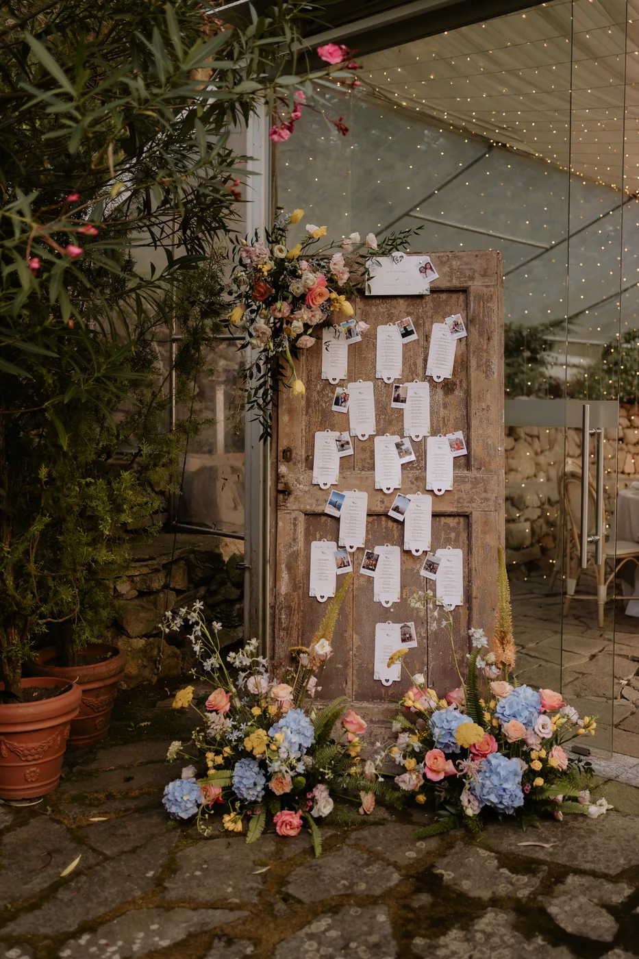 Seating chart on an old wooden door decorated with flowers