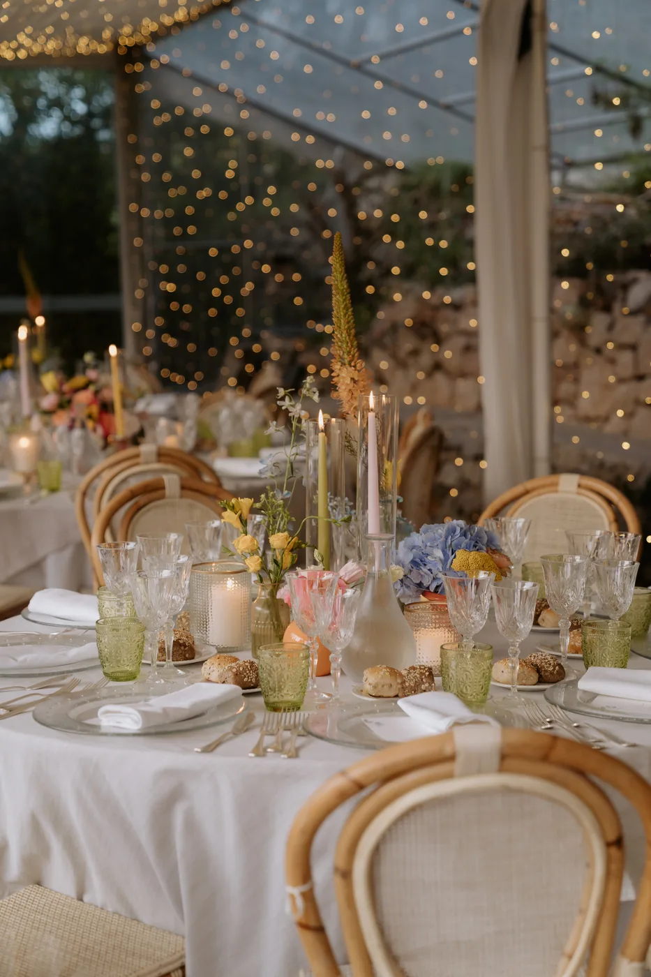 Table with hydrangeas, candles and string lights under the gazebo