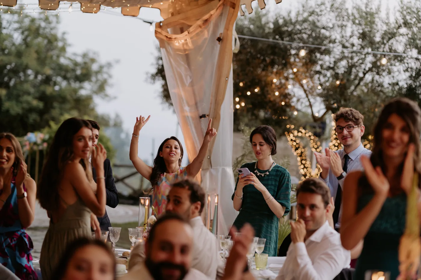 Friends cheering as the couple arrives