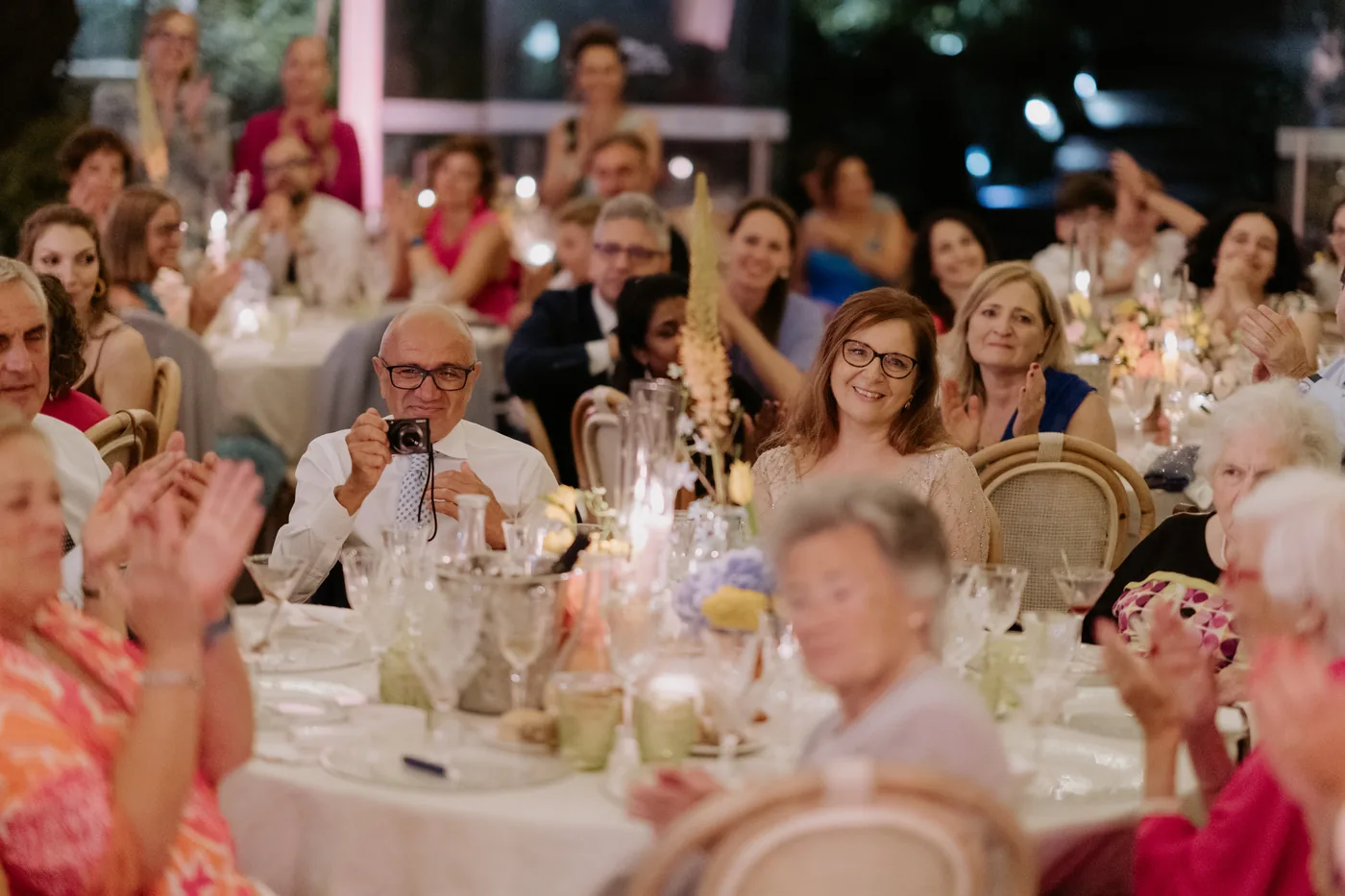Guests applauding from the dinner tables