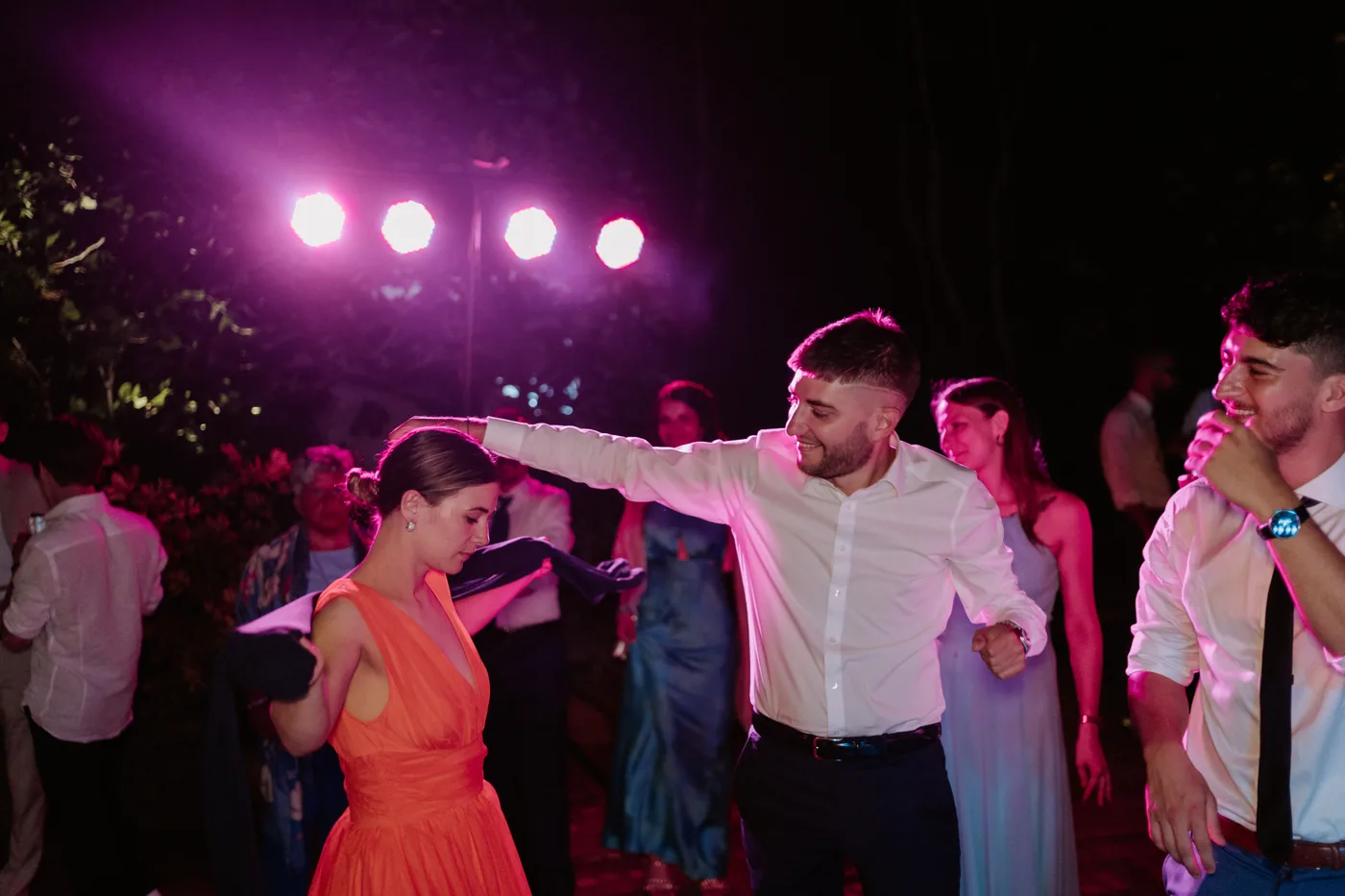 Guests dancing under the colorful dance floor lights