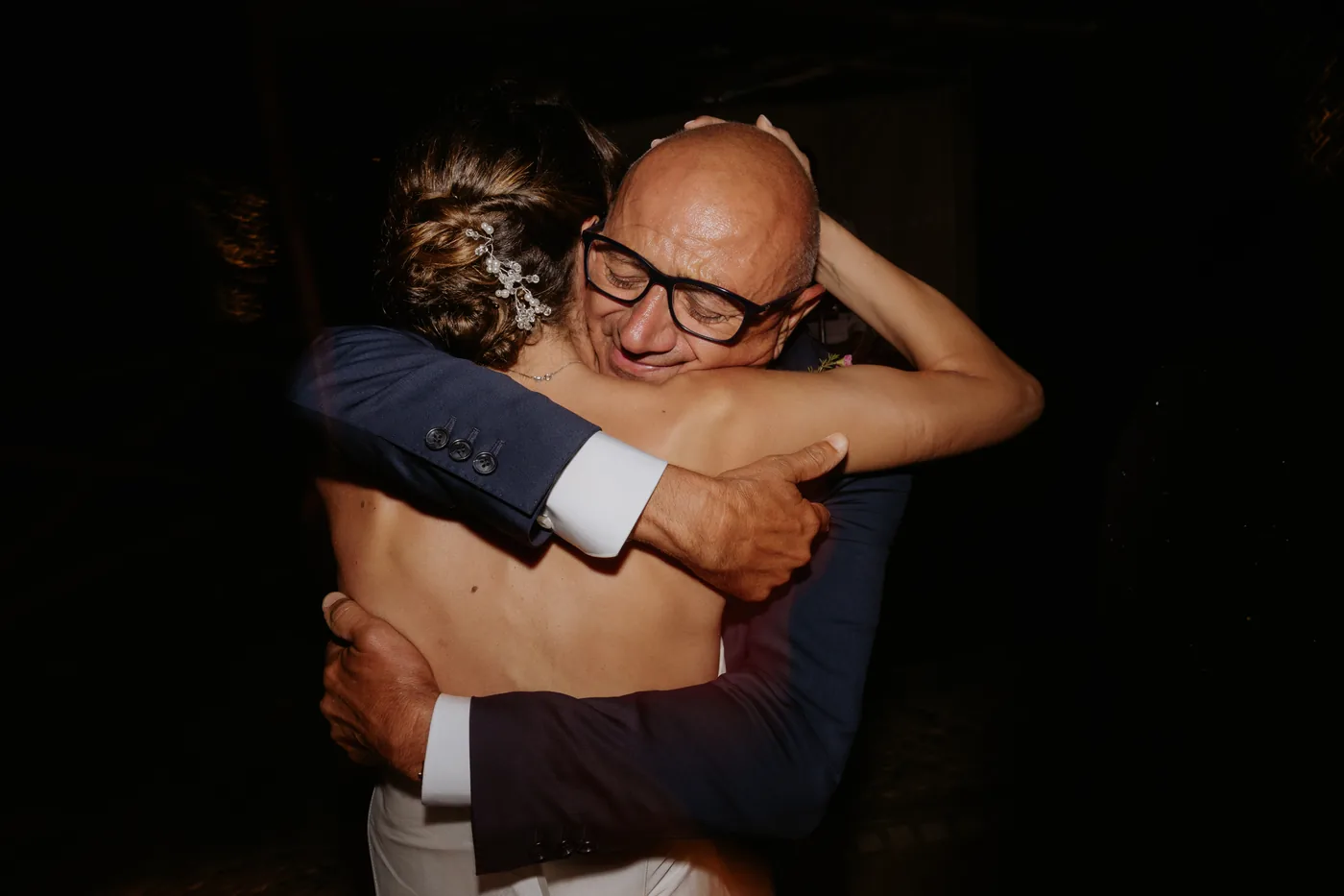The bride hugging a guest tight during the party