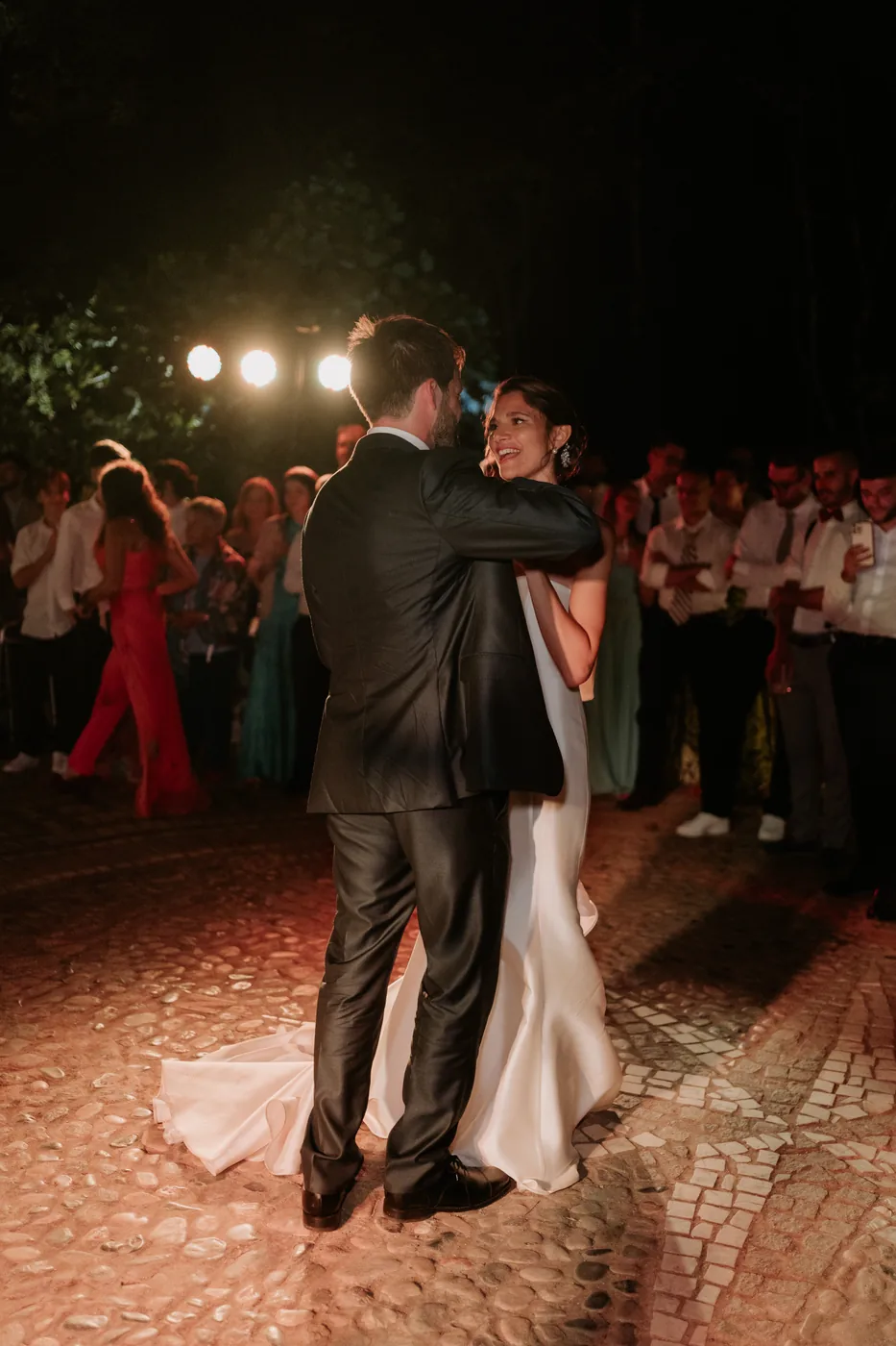 The couple's first dance under the lights among their guests