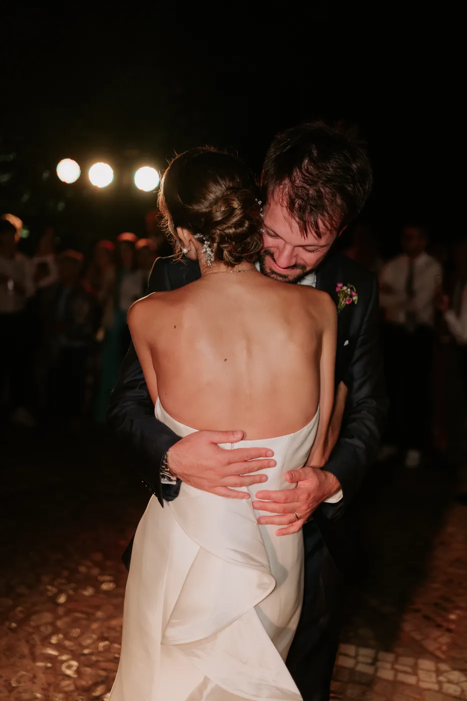 The groom laughing as he holds the bride during the dance